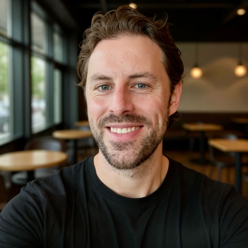 Portrait of TJ Aldridge smiling in a cafe